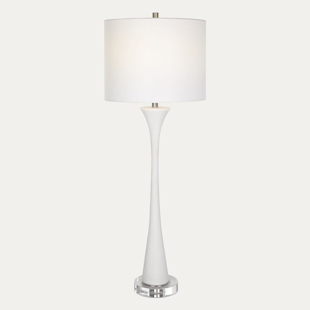 White table lamp with a cylindrical base and round shade on a white background