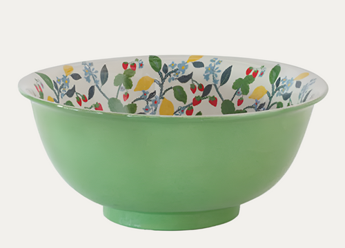 Green ceramic bowl with floral patterned interior on a white background
