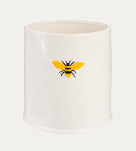White ceramic pot with a bee design on a white background