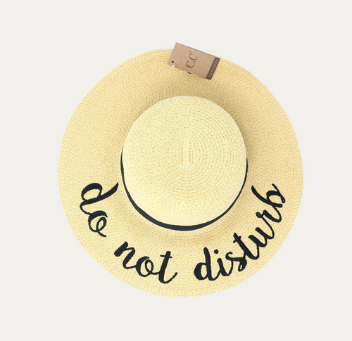 Beige straw hat with 'do not disturb' text on a white background
