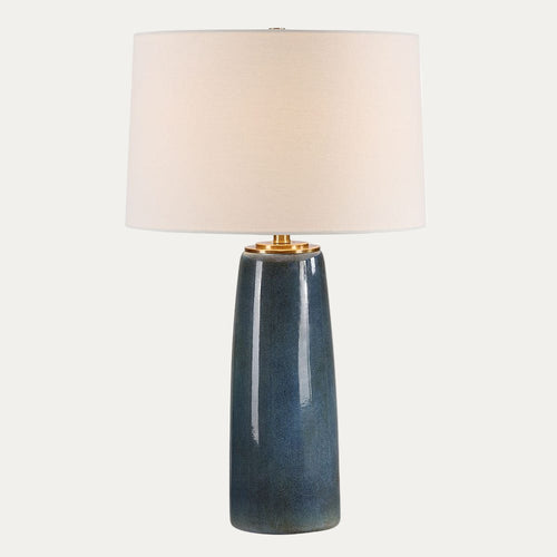 Table lamp with a blue ceramic base and white shade on a white background